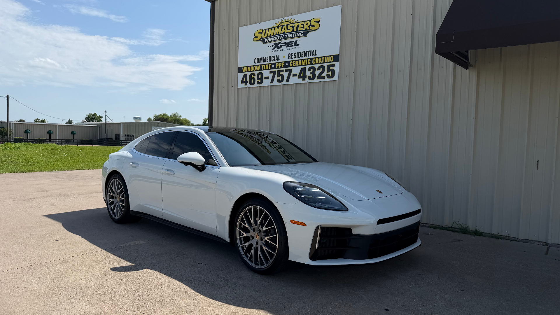 White Porsche outside Sunmasters Window Tinting shop